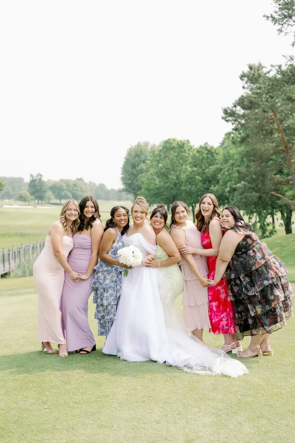 image shows a bride and her bridal party on her wedding day