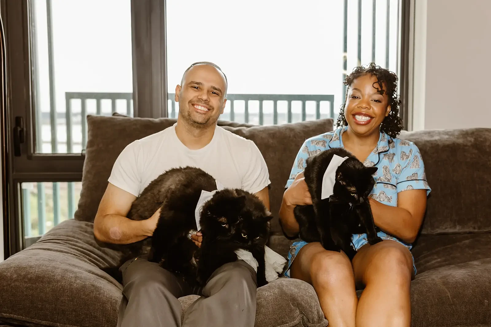 image shows our real bride and her husband smiling with their cats