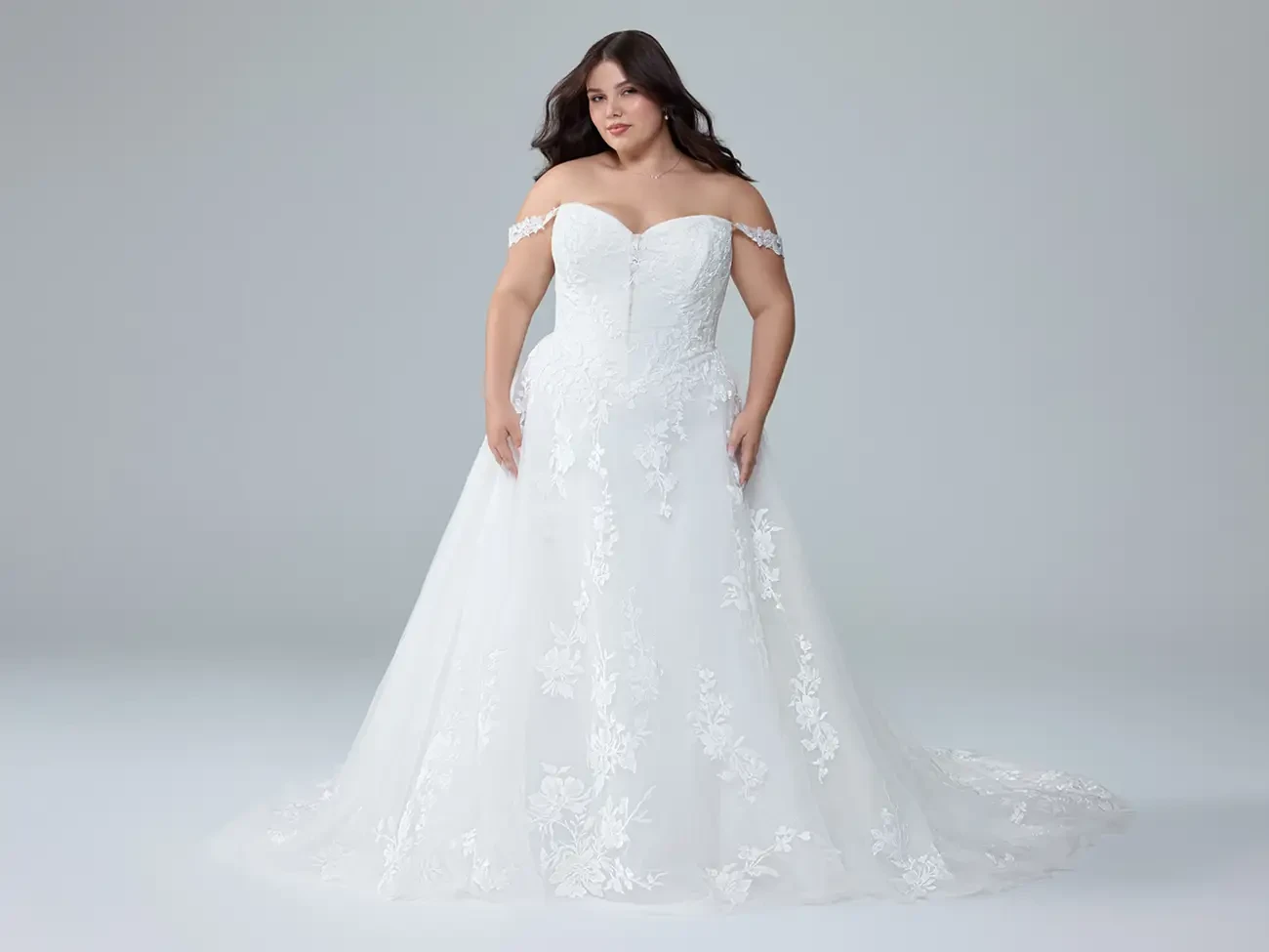 Plus size model in white Sophia Tolli dress