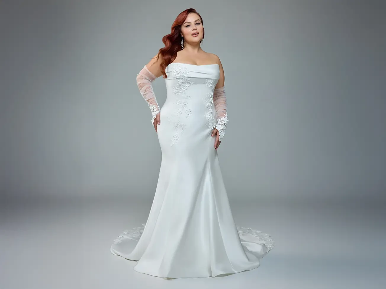 Plus size model in white Sophia Tolli dress