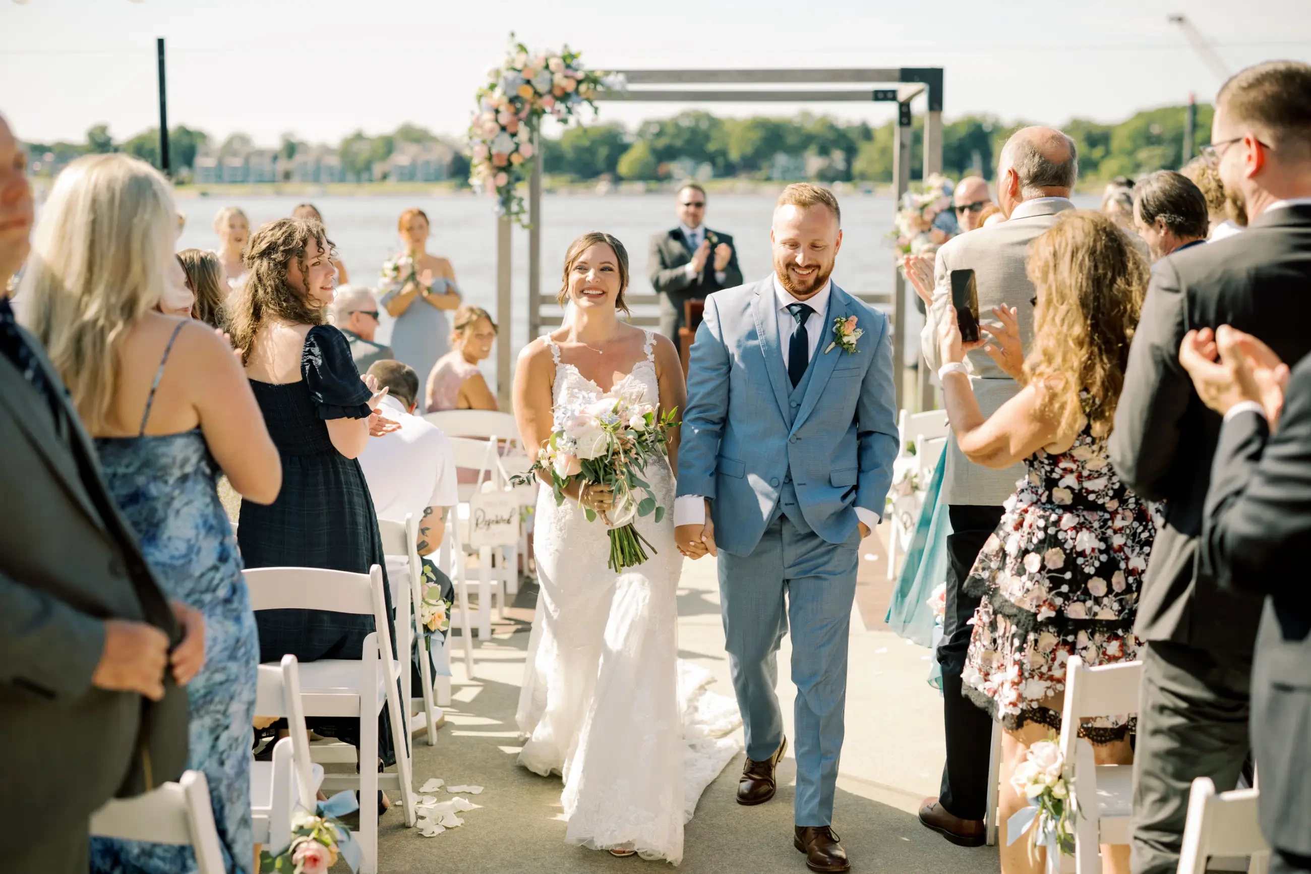 Image shows a husband and wife walking back down the aisle after getting married