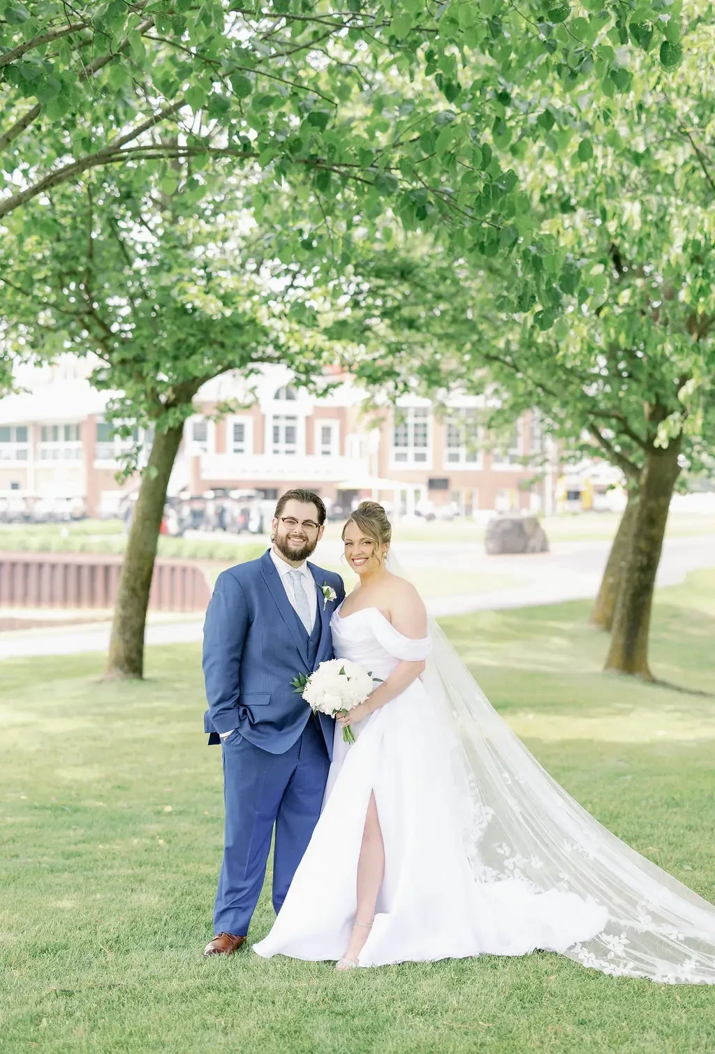image shows a husband and wife smiling toward the camera on their wedding day