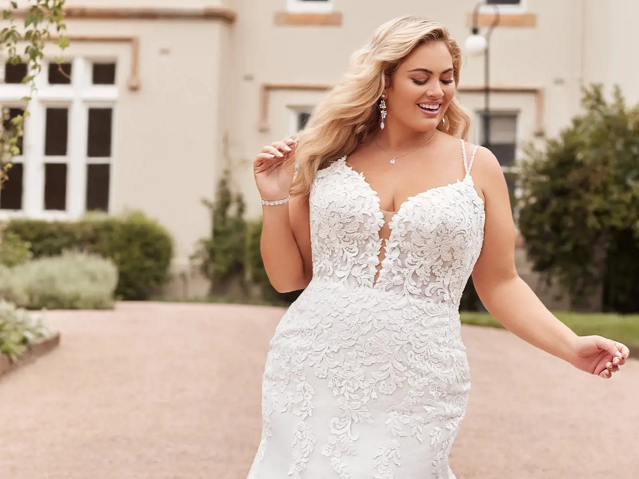 Plus size model in white Sophia Tolli dress