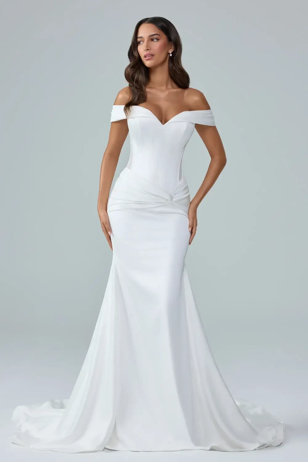 model is wearing a fitted off the shoulder bridal gown