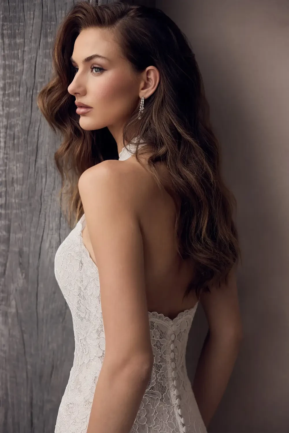 model is wearing an open back high neck wedding dress