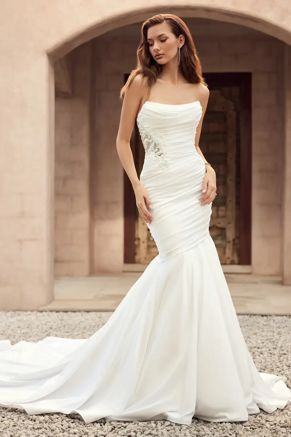 model is wearing a strapless fit and flare bridal gown