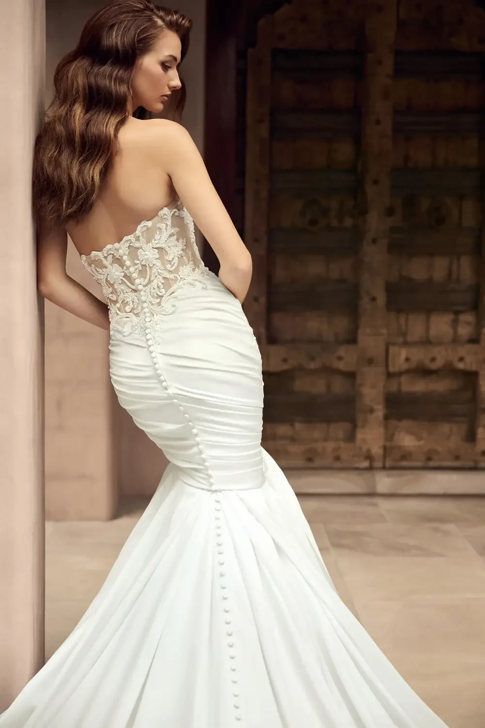 model is wearing a strapless fit and flare bridal gown