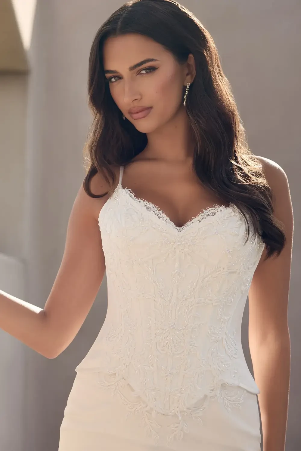 model is wearing an open back sleeveless bridal gown